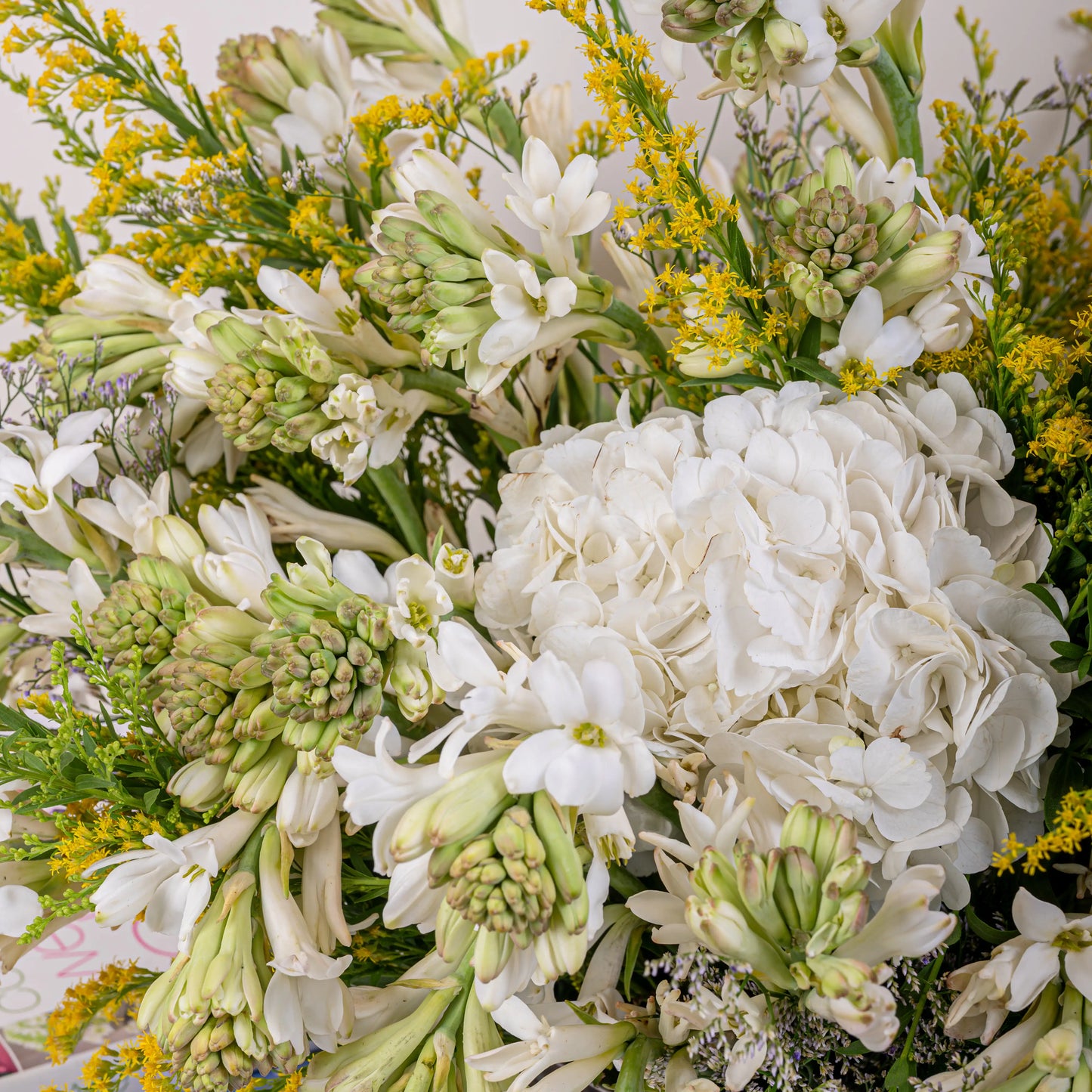 Alabaster premium white floral arrangement with white roses and lilies in elegant glass vase by House of Mograa