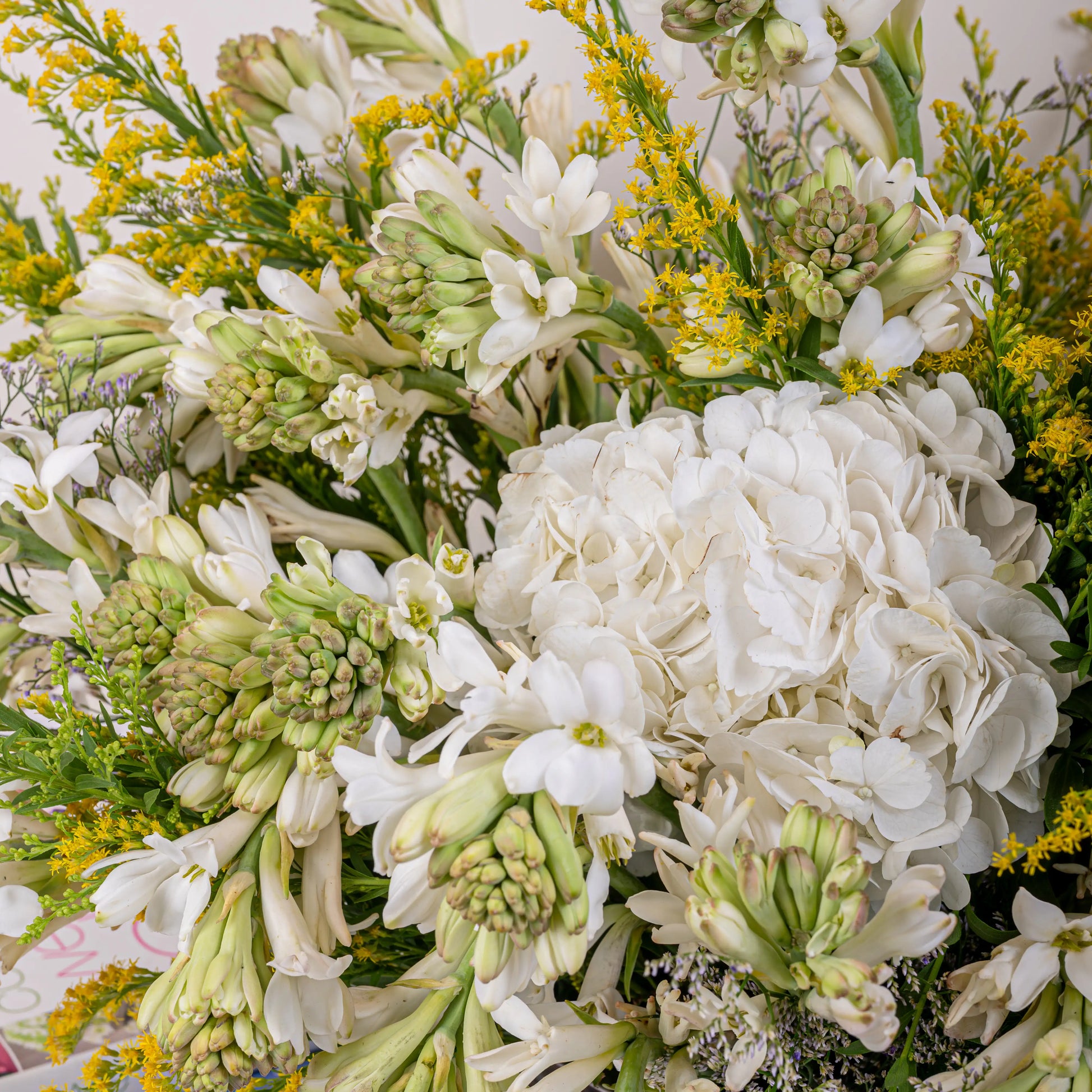 Alabaster premium white floral arrangement with white roses and lilies in elegant glass vase by House of Mograa