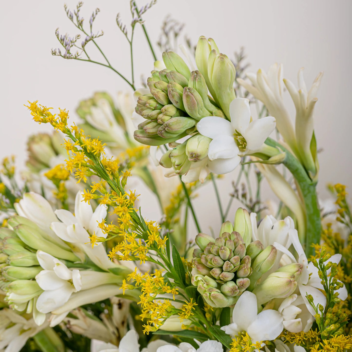 Alabaster premium white floral arrangement with white roses and lilies in elegant glass vase by House of Mograa
