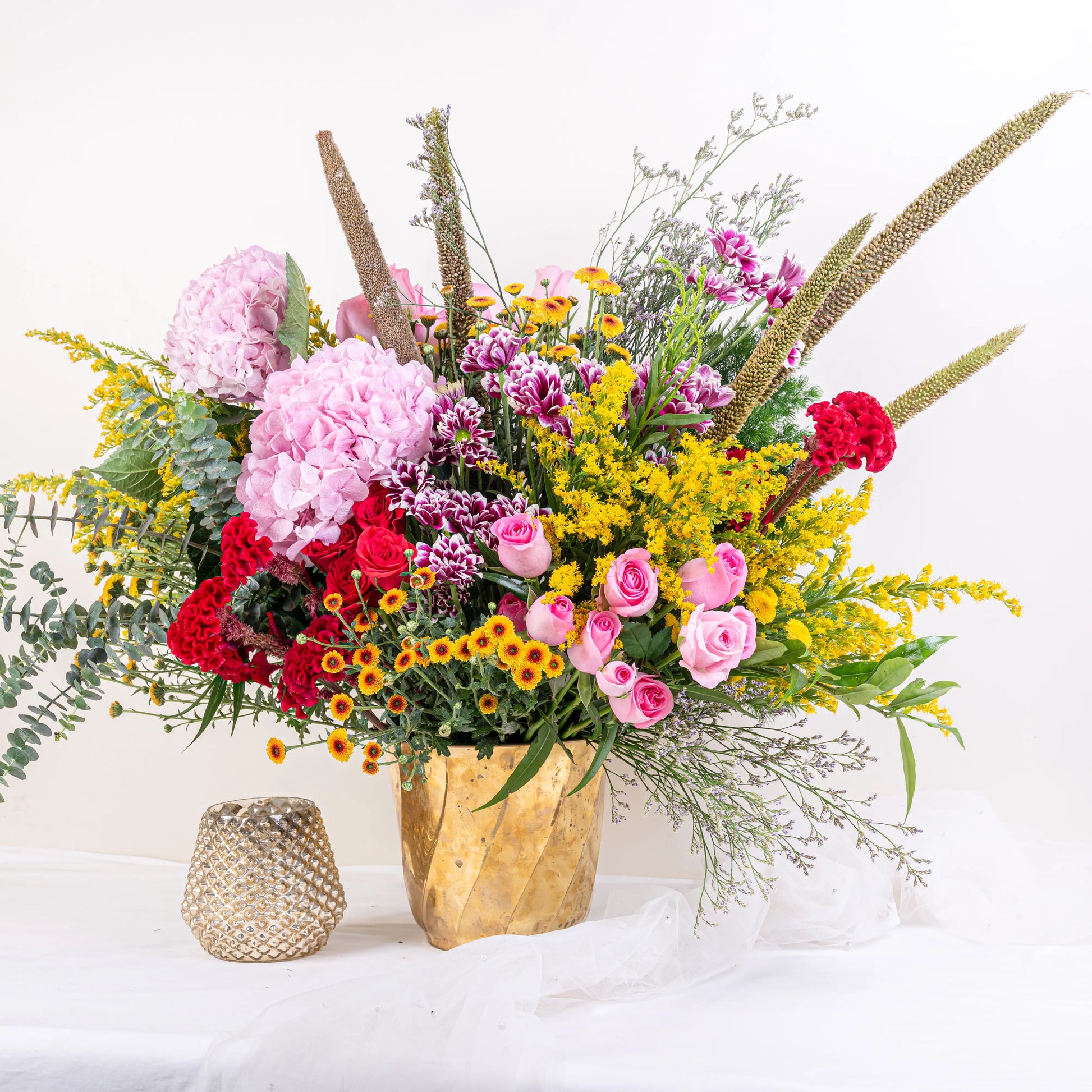Blush and Flame red and pink floral arrangement with red roses and pink blooms in premium container by House of Mograa