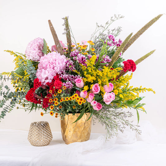 Blush and Flame red and pink floral arrangement with red roses and pink blooms in premium container by House of Mograa