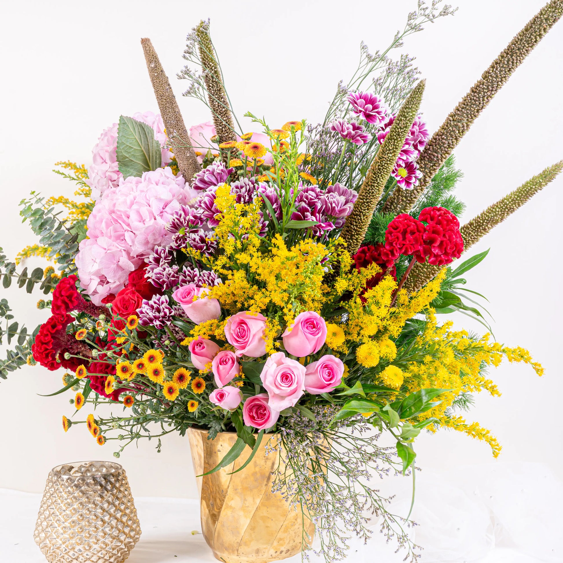 Blush and Flame red and pink floral arrangement with red roses and pink blooms in premium container by House of Mograa