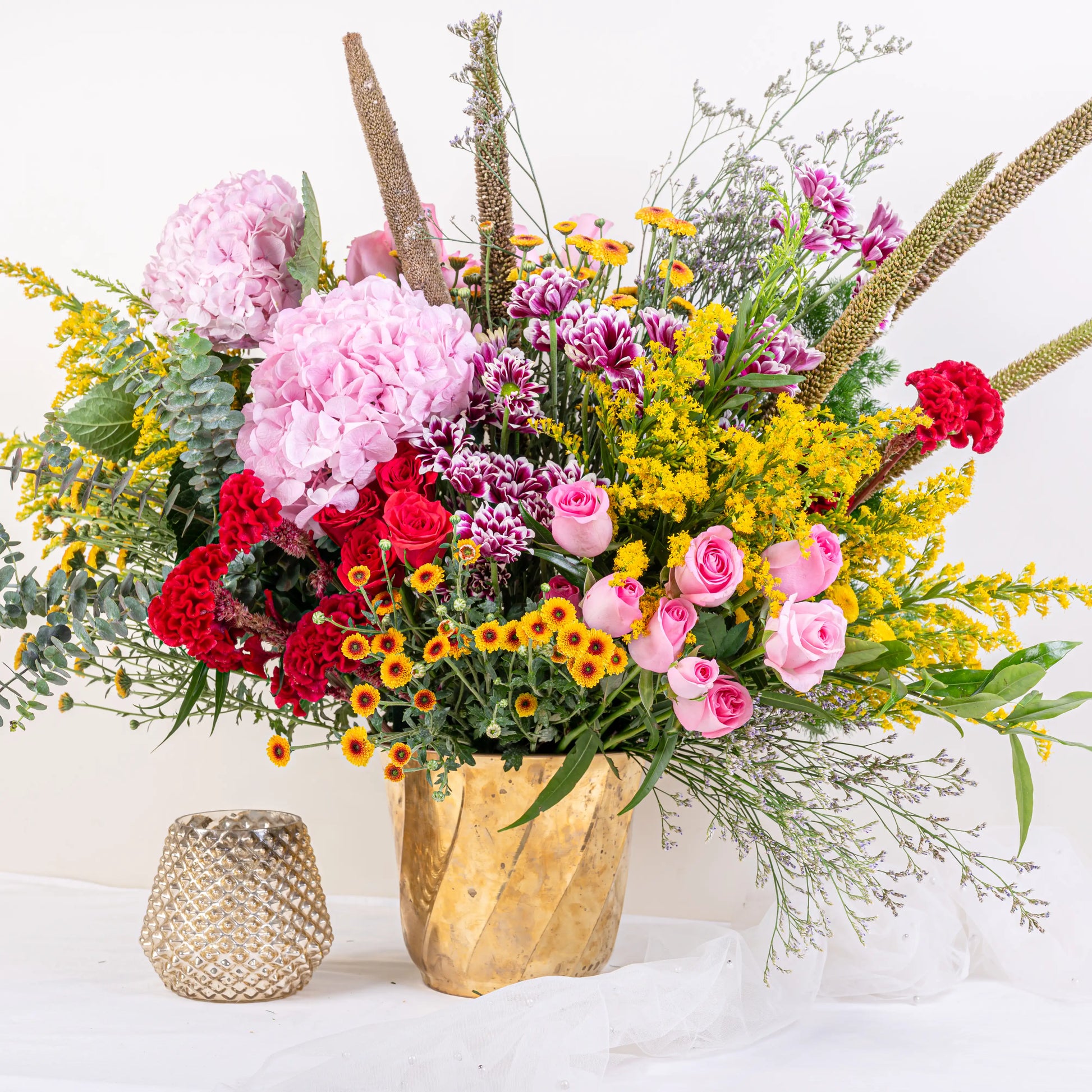 Blush and Flame red and pink floral arrangement with red roses and pink blooms in premium container by House of Mograa