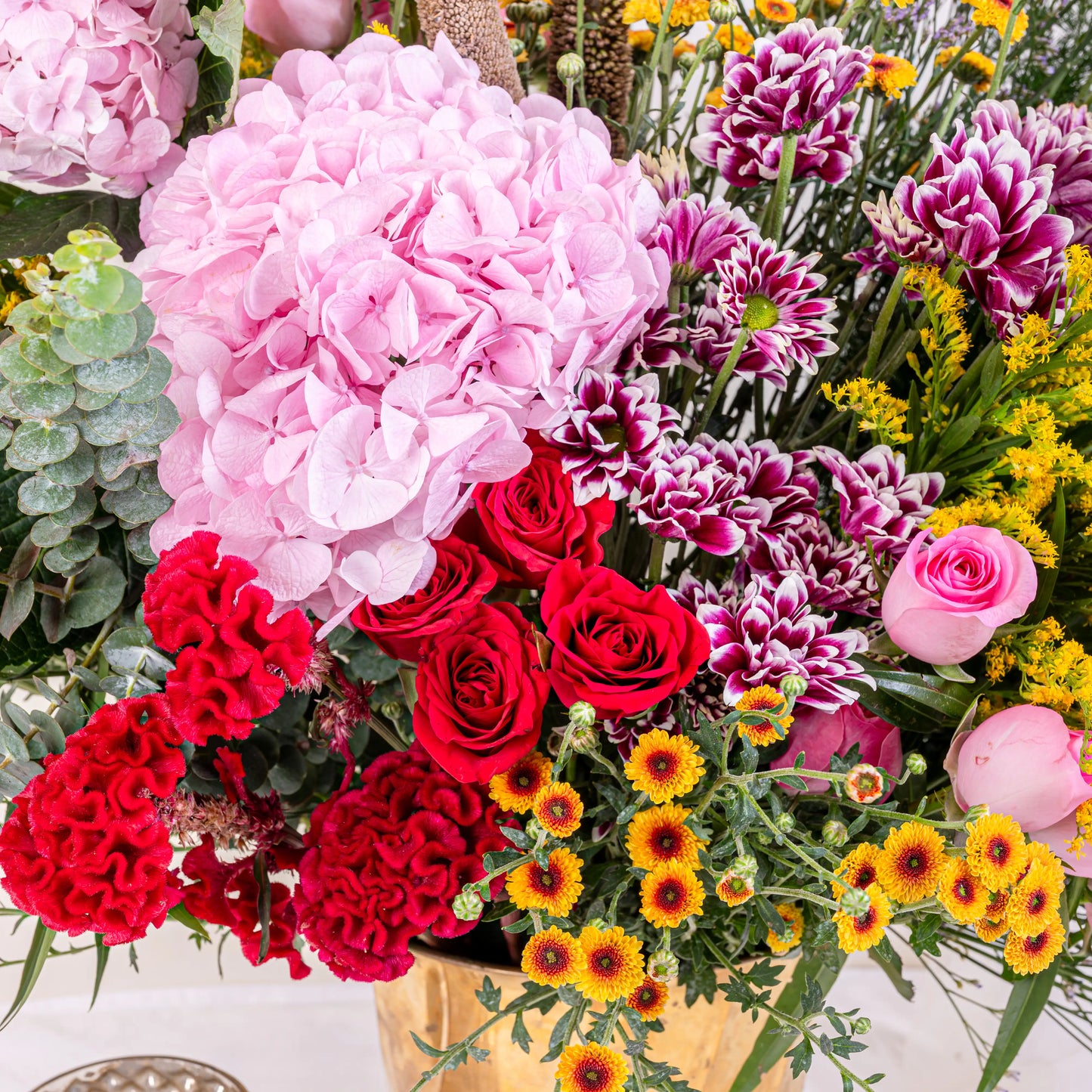 Blush and Flame red and pink floral arrangement with red roses and pink blooms in premium container by House of Mograa