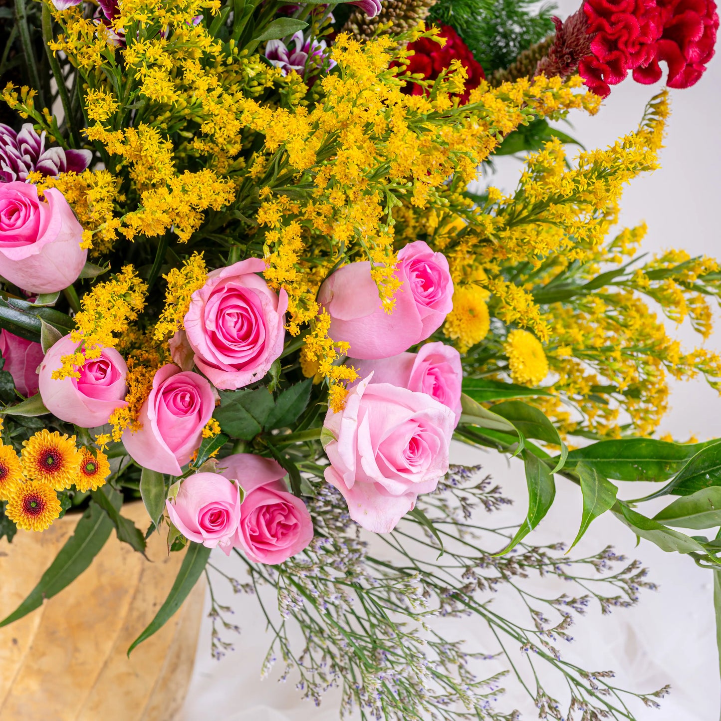 Blush and Flame red and pink floral arrangement with red roses and pink blooms in premium container by House of Mograa