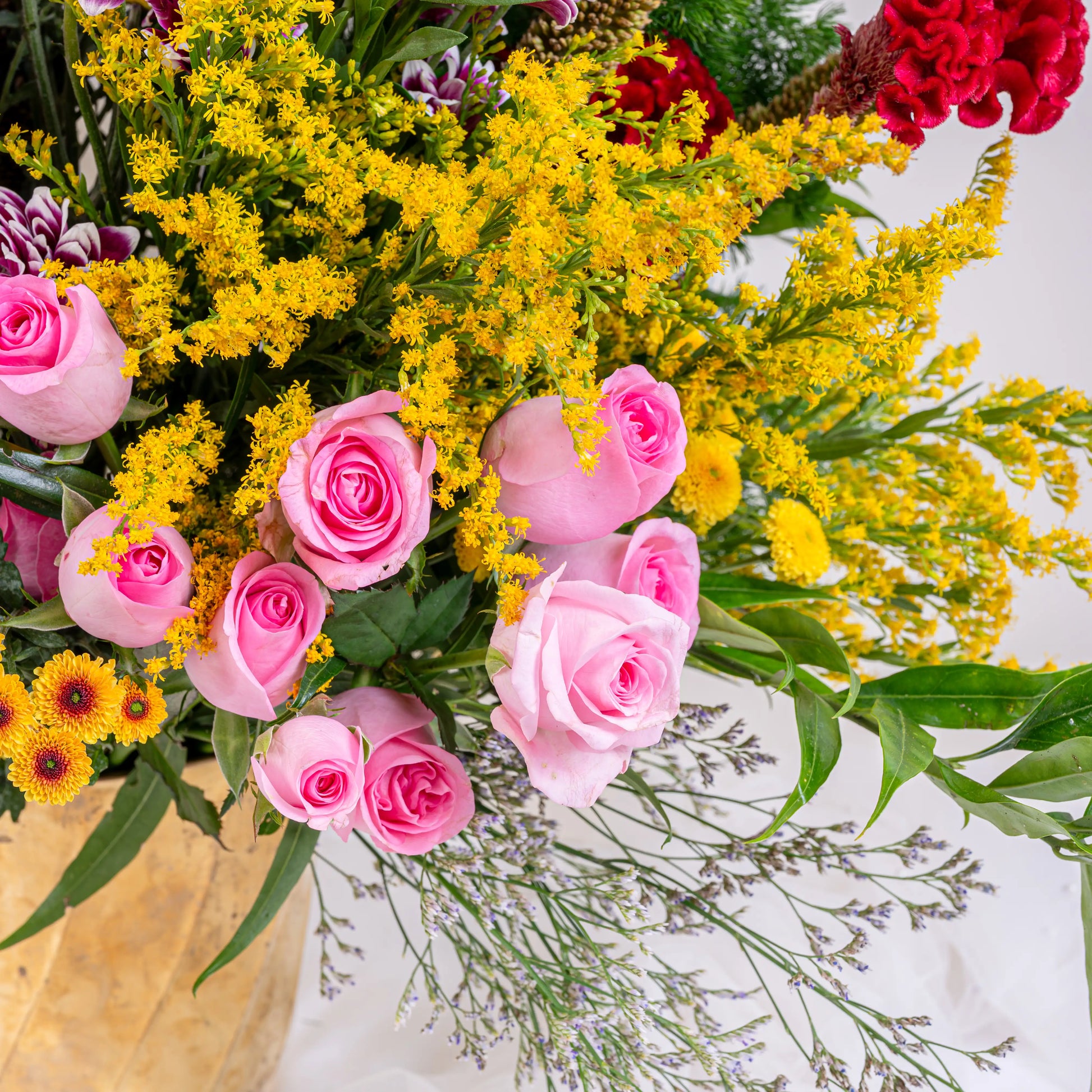 Blush and Flame red and pink floral arrangement with red roses and pink blooms in premium container by House of Mograa