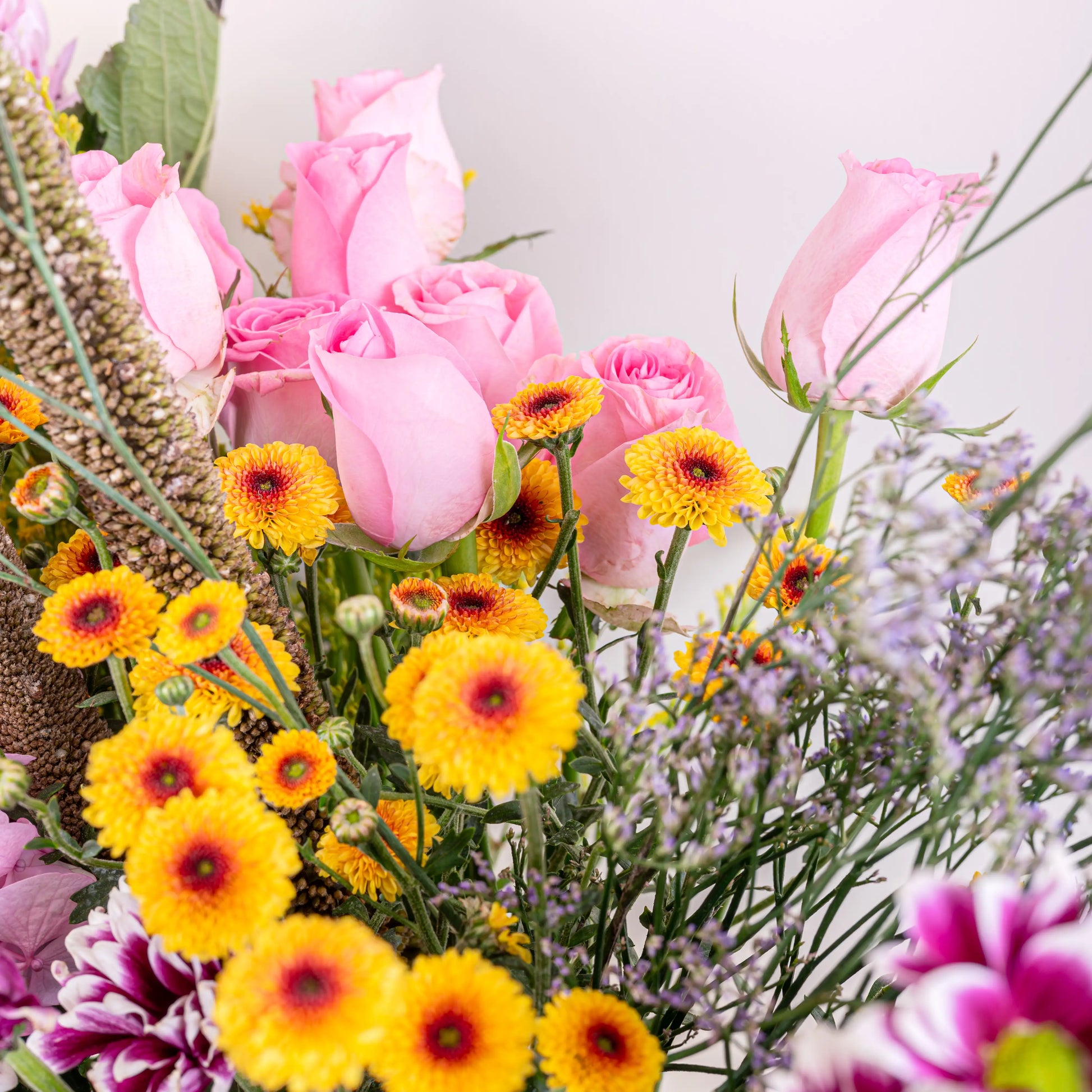 Blush and Flame red and pink floral arrangement with red roses and pink blooms in premium container by House of Mograa