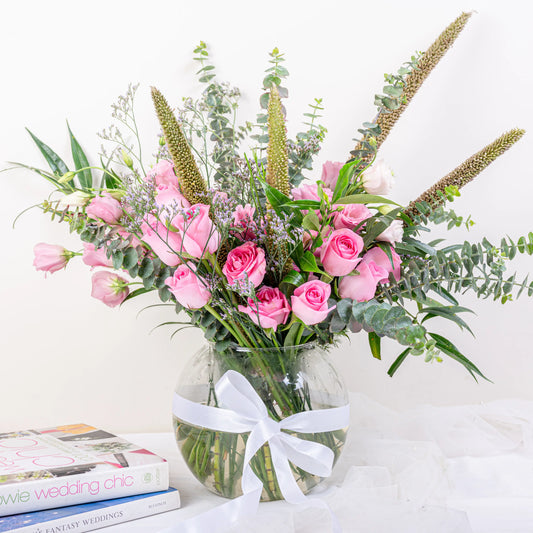 Blush Garden pink rose and eucalyptus fishbowl arrangement with lisianthus and veronica in glass vase by House of Mograa