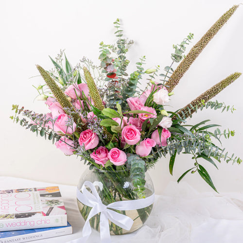 Blush Garden pink rose and eucalyptus fishbowl arrangement with lisianthus and veronica in glass vase by House of Mograa