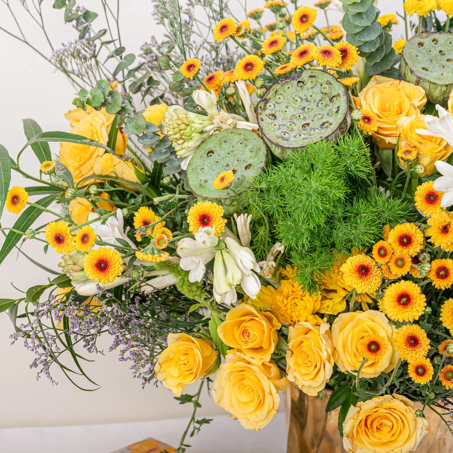 Citrus & Ivory luxury centerpiece with yellow roses, white hydrangea, gerberas, tuberose and eucalyptus in gold geometric vase by House of Mograa