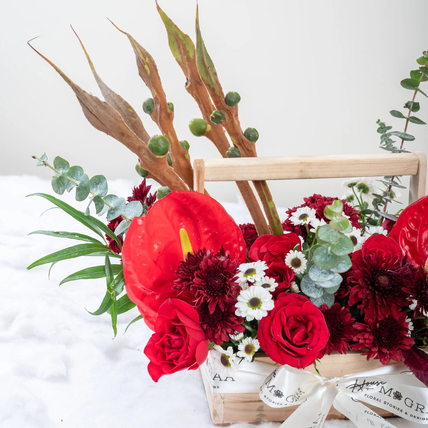 Crimson Fusion red rose and red anthurium mixed arrangement with greenery by House of Mograa