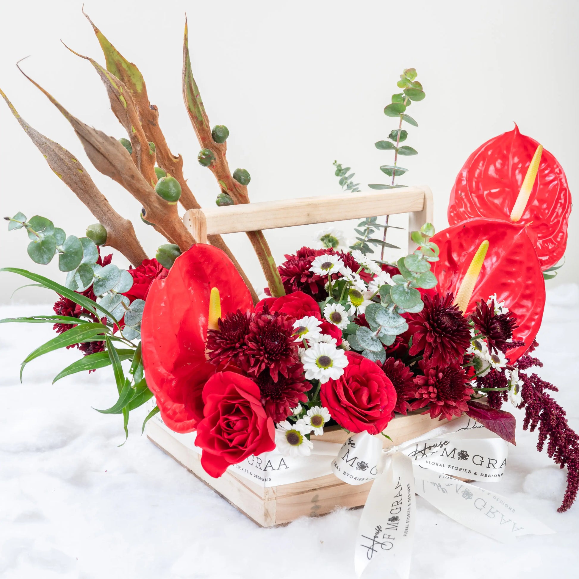 Crimson Fusion red rose and red anthurium mixed arrangement with greenery by House of Mograa