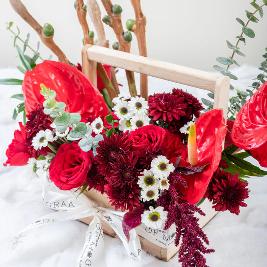 Crimson Fusion red rose and red anthurium mixed arrangement with greenery by House of Mograa