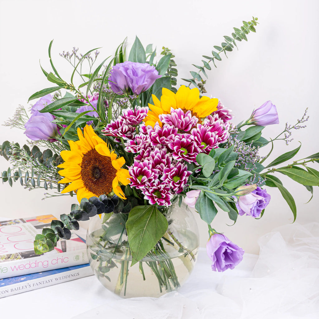 Helios premium sunflower arrangement with bright yellow sunflowers in glass vase by House of Mograa