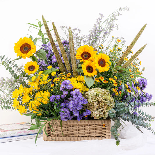 Fresh sunflower basket arrangement with 8-12 yellow sunflowers in natural woven basket by House of Mograa